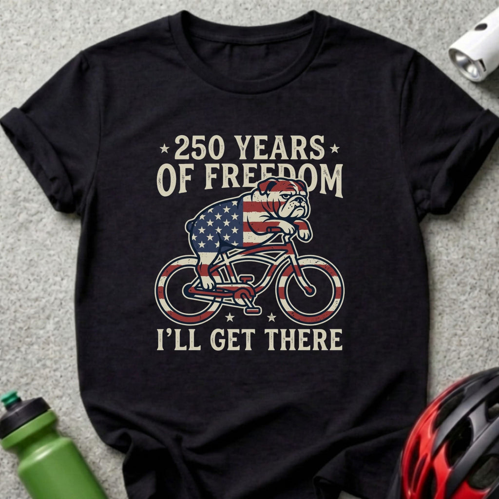 Bulldog on bicycle with American flag, "250 Years of Freedom I'll Get There."