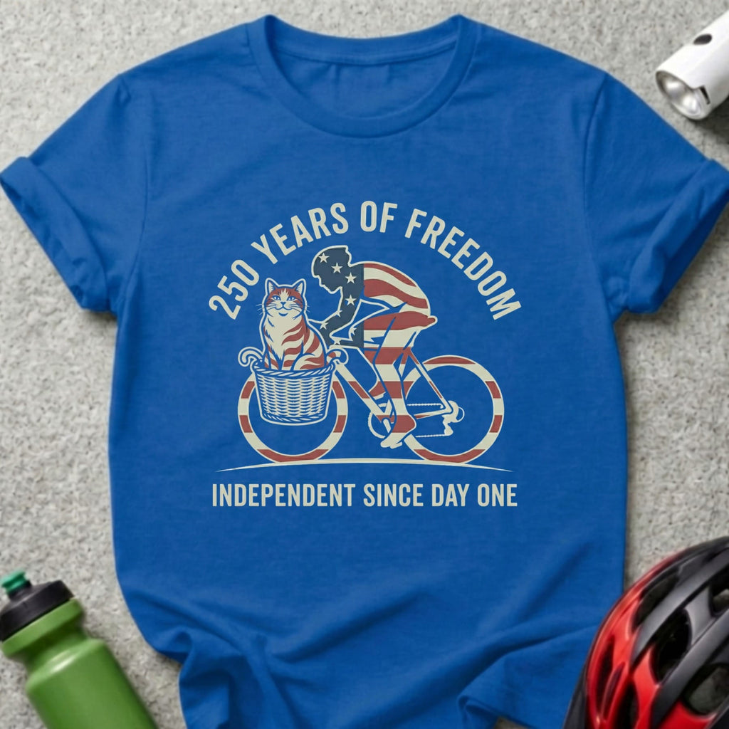 Blue t-shirt with cat on bicycle graphic celebrating 250 years of freedom.