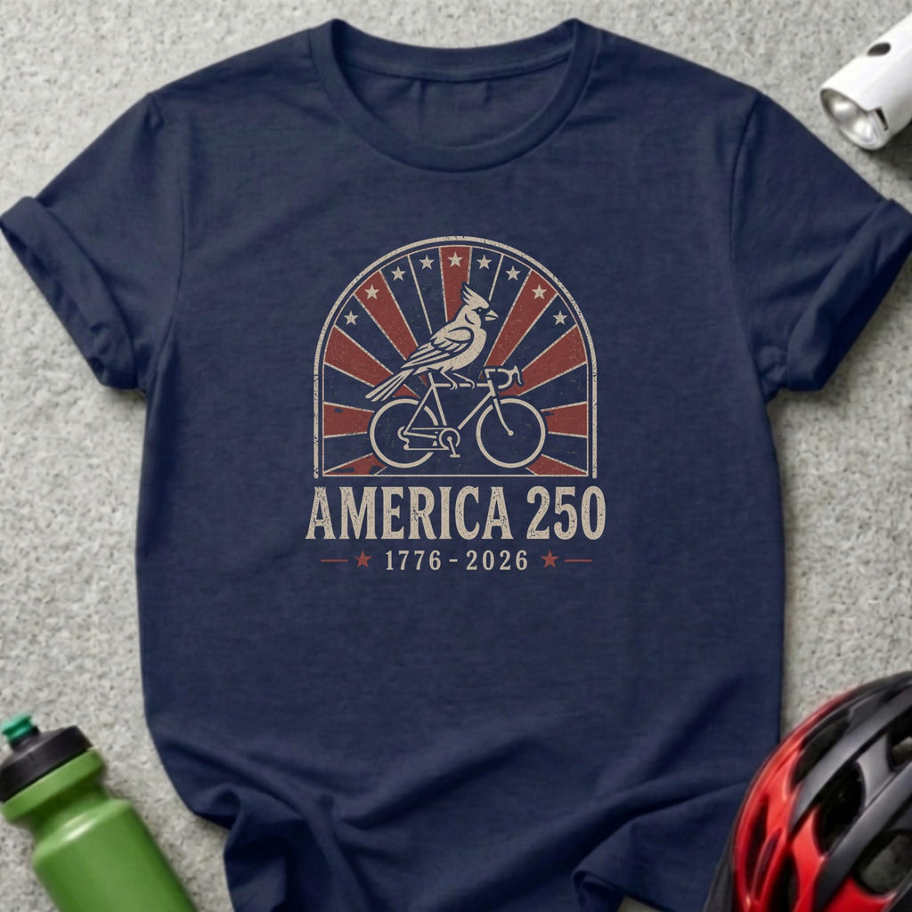 Navy t-shirt with "America 250" text, cardinal on bicycle, and US flag motif.