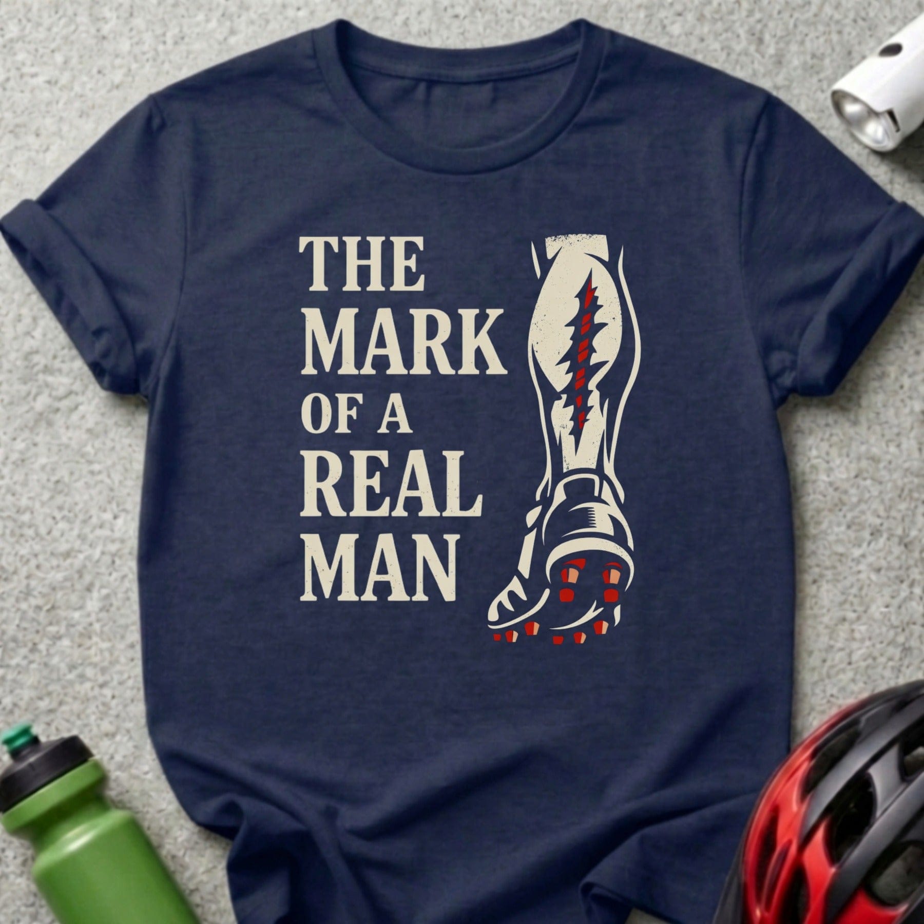Navy t-shirt with text "The Mark of a Real Man" and a graphic of a soccer cleat.