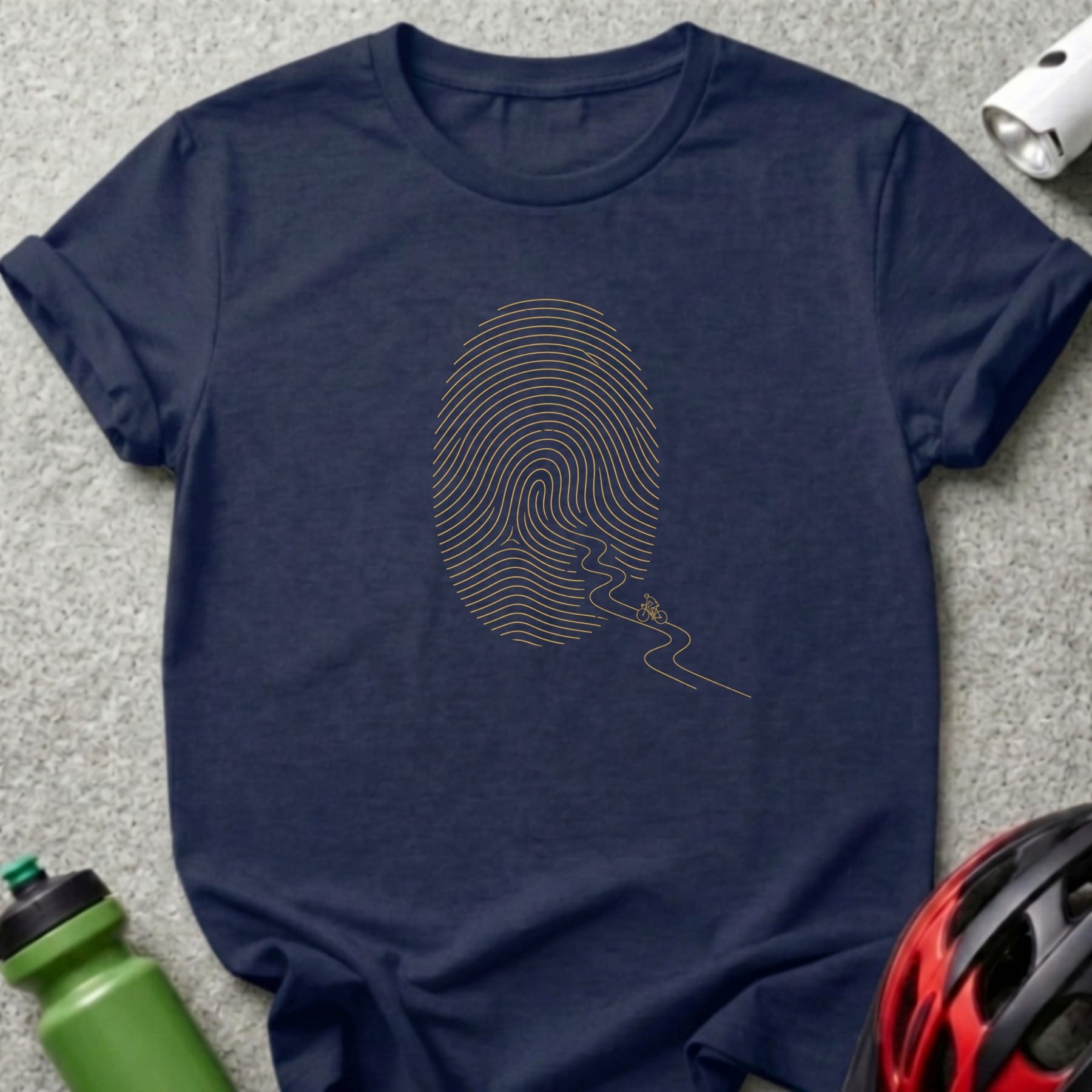 Navy t-shirt with gold fingerprint graphic and a cyclist on a winding path.
