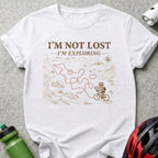 White t-shirt with "I'm Not Lost - I'm Exploring" and cyclist on a map.