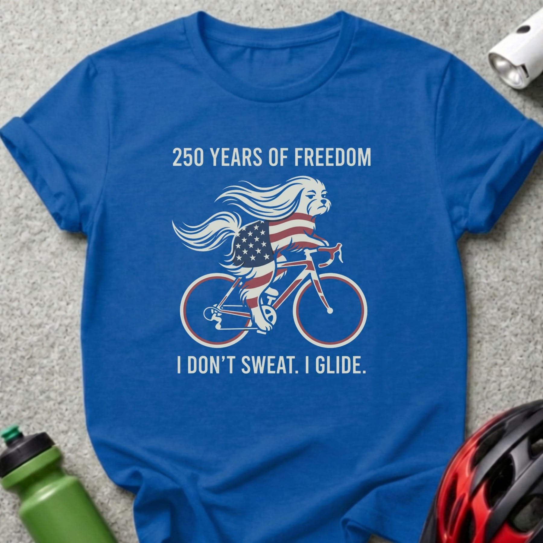 Blue t-shirt with dog on bicycle, "250 Years of Freedom" and "I Don't Sweat. I Glide."