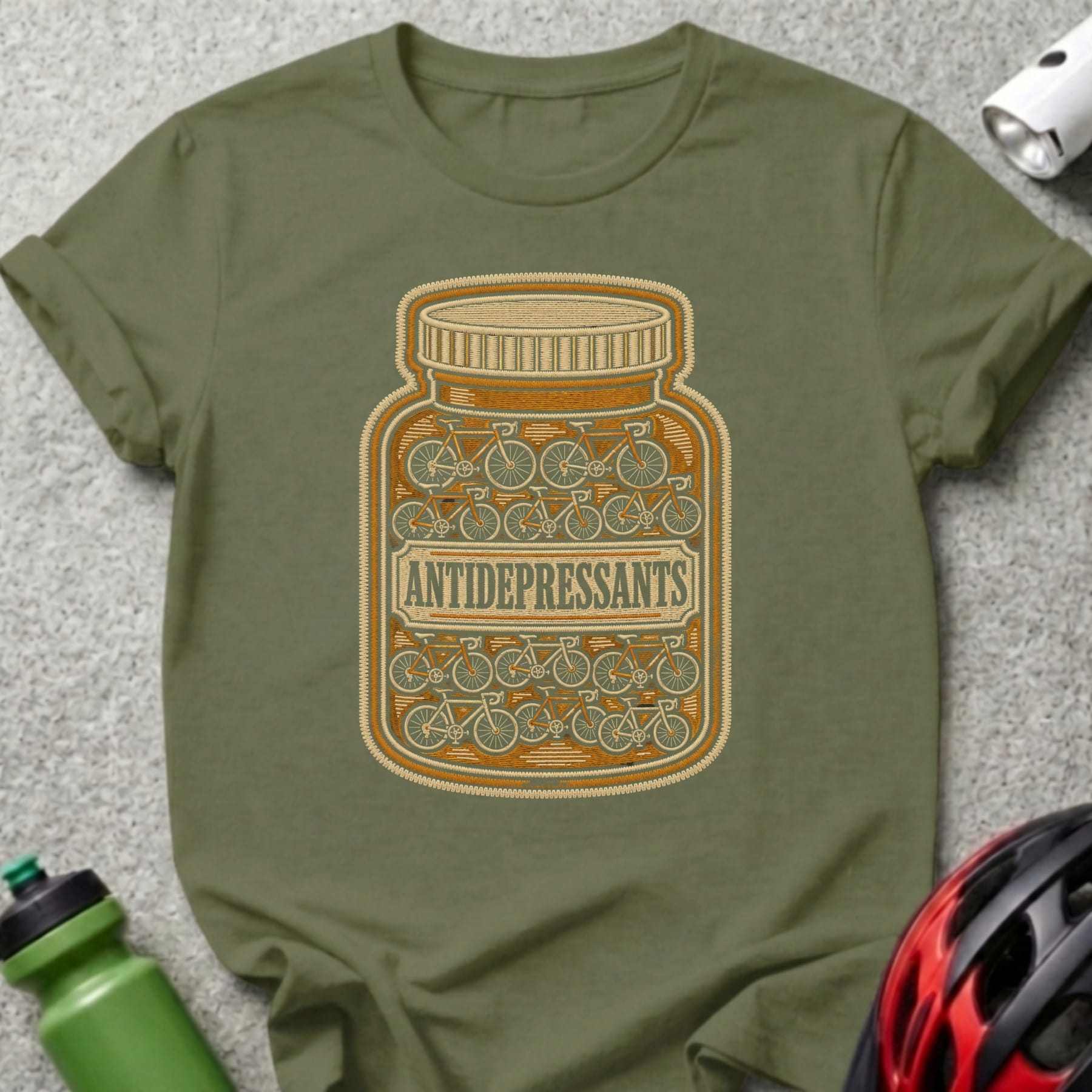 Olive green t-shirt with a pill bottle graphic filled with bicycles, labeled "ANTIDEPRESSANTS".