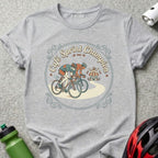 Two cyclists racing past a cafe, with "Cafe Sprint Champion" text.