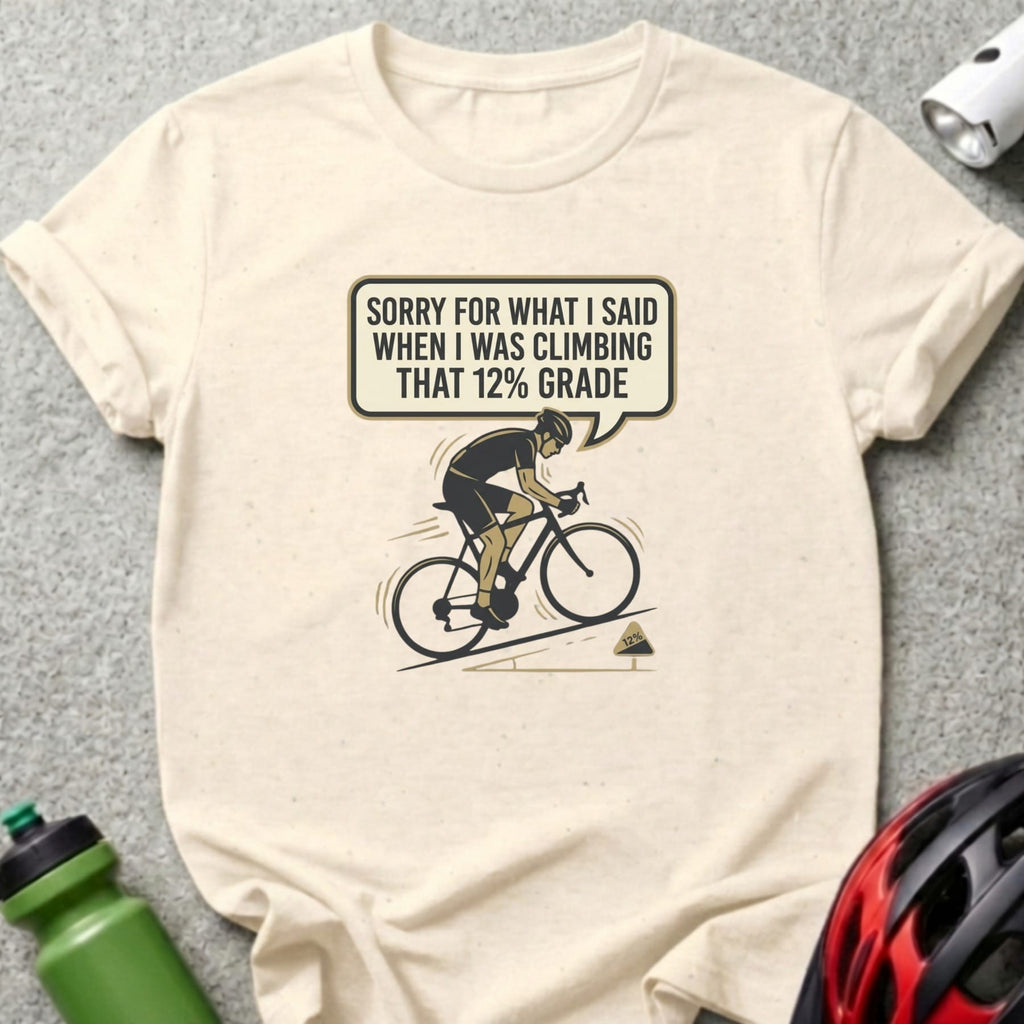 T-shirt with cyclist graphic and text "Sorry for what I said when I was climbing that 12% grade".