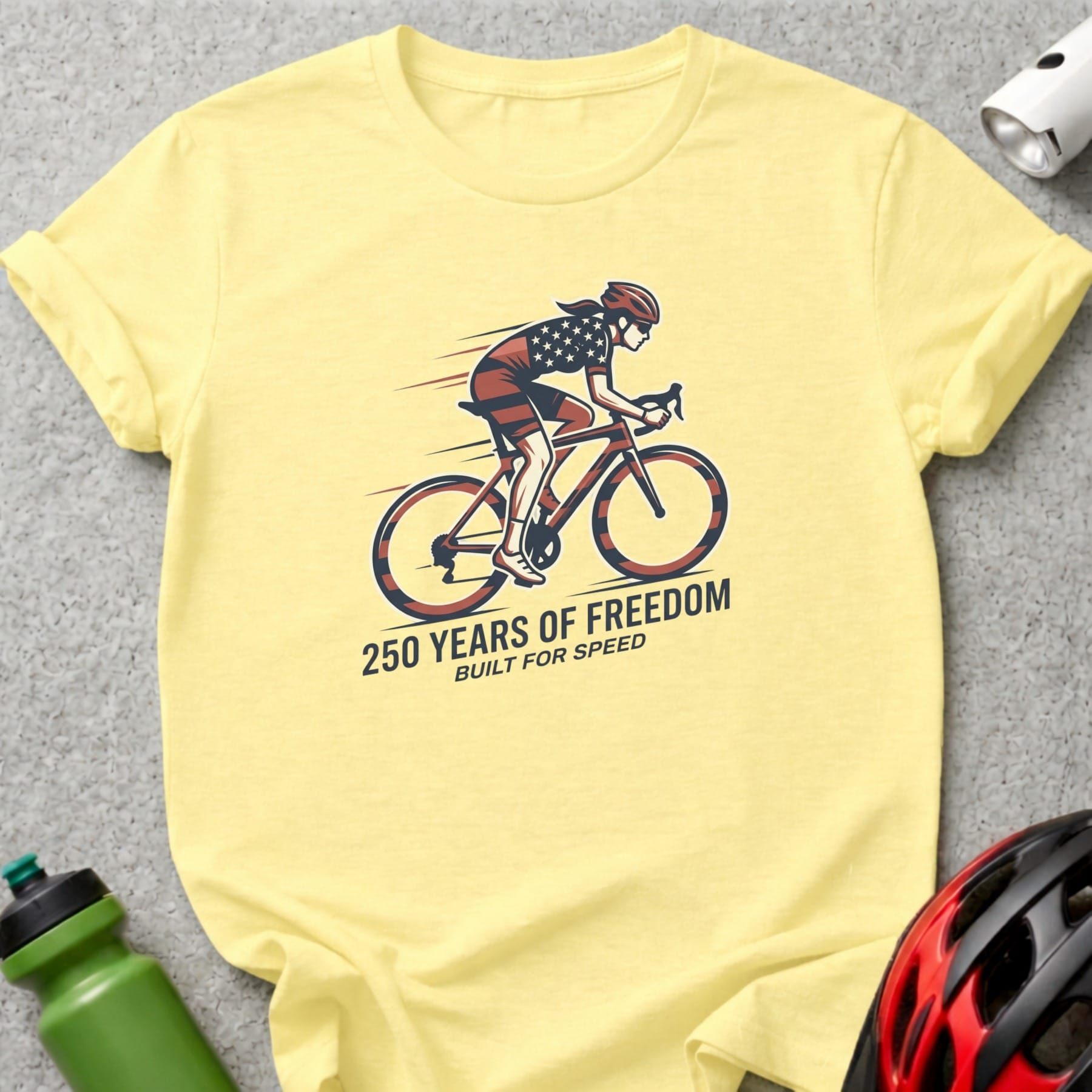 Yellow t-shirt with cyclist graphic and text "250 Years of Freedom, Built for Speed".