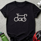 A black t-shirt features a white graphic of a bicycle with wheels and frame forming the word "dad".