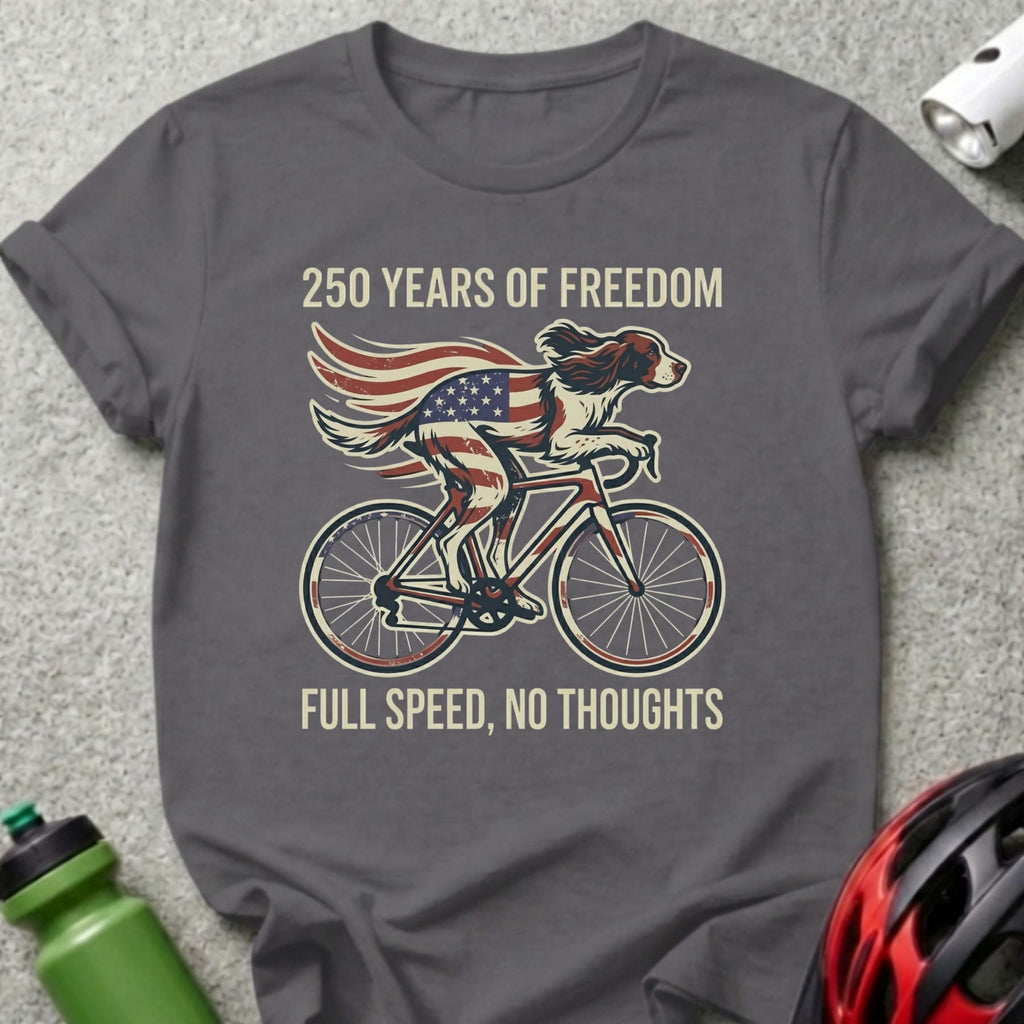 Dog wearing American flag wings rides bicycle, "250 Years of Freedom, Full Speed, No Thoughts."