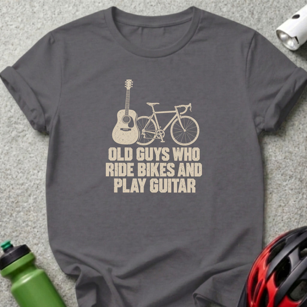 Dark gray crewneck t-shirt featuring an acoustic guitar, bicycle graphic, and text reading Old Guys Who Ride Bikes And Play Guitar.