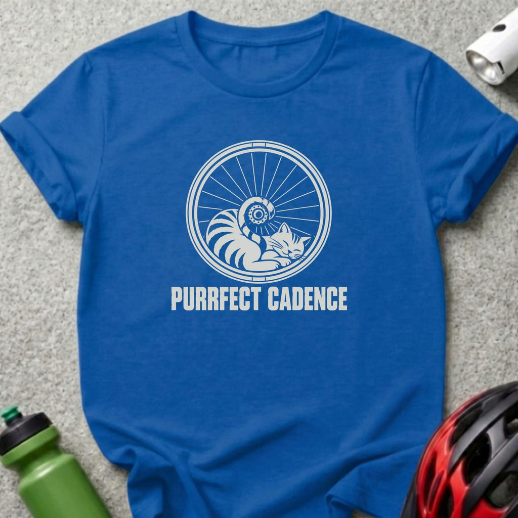 Royal blue t-shirt featuring a white graphic of a cat sleeping inside a bicycle wheel with the text "PURRFECT CADENCE".