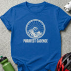 Royal blue t-shirt featuring a white graphic of a cat sleeping inside a bicycle wheel with the text "PURRFECT CADENCE".