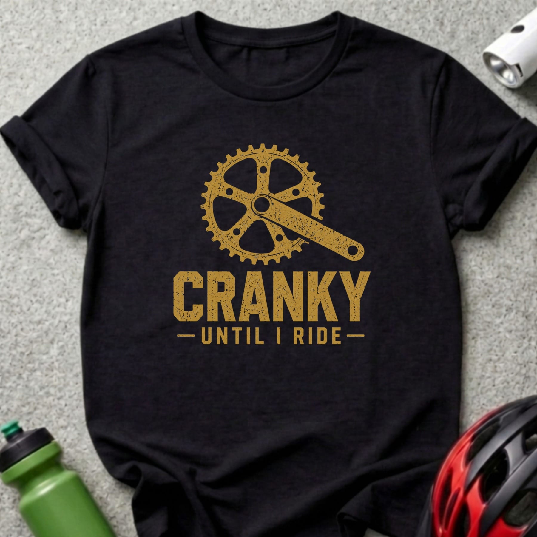 Black t-shirt with gold graphic of a bicycle crank and "CRANKY UNTIL I RIDE" text.