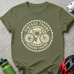 Olive green t-shirt with circular "Vintage Frame Modern Engine" bicycle graphic.