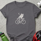 Dark grey t-shirt with a white graphic of an owl on a bicycle under a crescent moon.