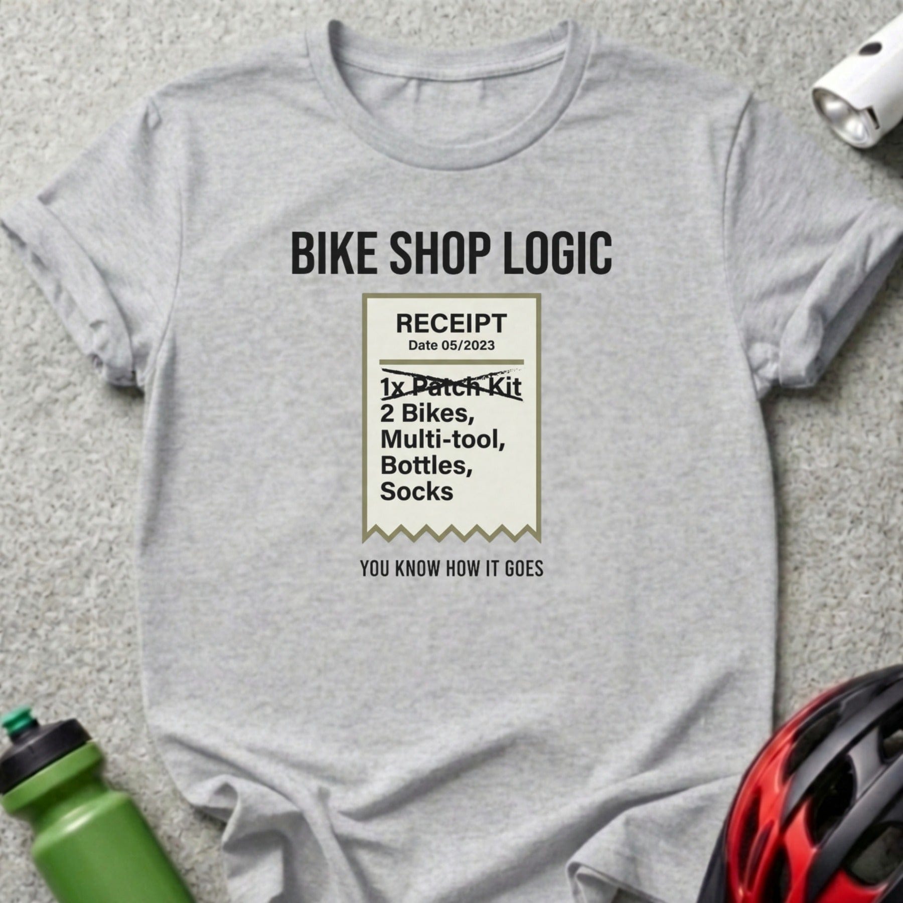 T-shirt with "Bike Shop Logic" receipt listing items and humor.
