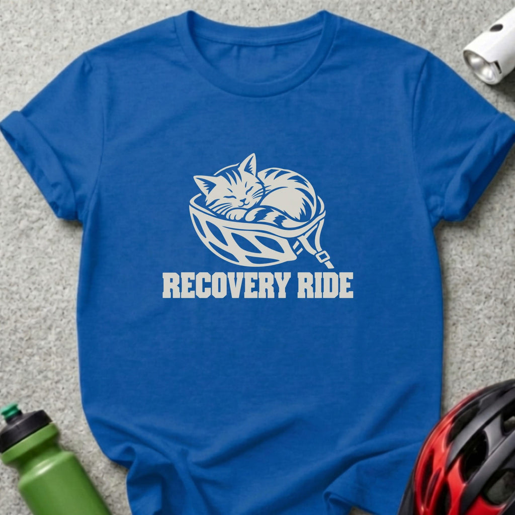 Blue crewneck t-shirt featuring a white graphic of a sleeping cat inside a bicycle helmet with the text RECOVERY RIDE.