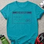 Turquoise t-shirt with "OUT OF OFFICE" and bicycle graphic.