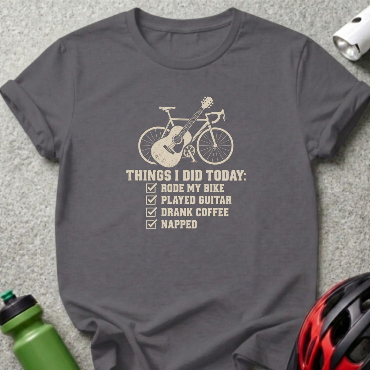Dark gray crewneck t-shirt featuring a graphic of a bicycle, guitar, and checklist text reading Things I Did Today.