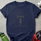Dark navy t-shirt with gold outline graphic of a bicycle and the word CADENCE.