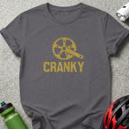 Dark grey t-shirt with gold glitter bicycle crank and "CRANKY" text.