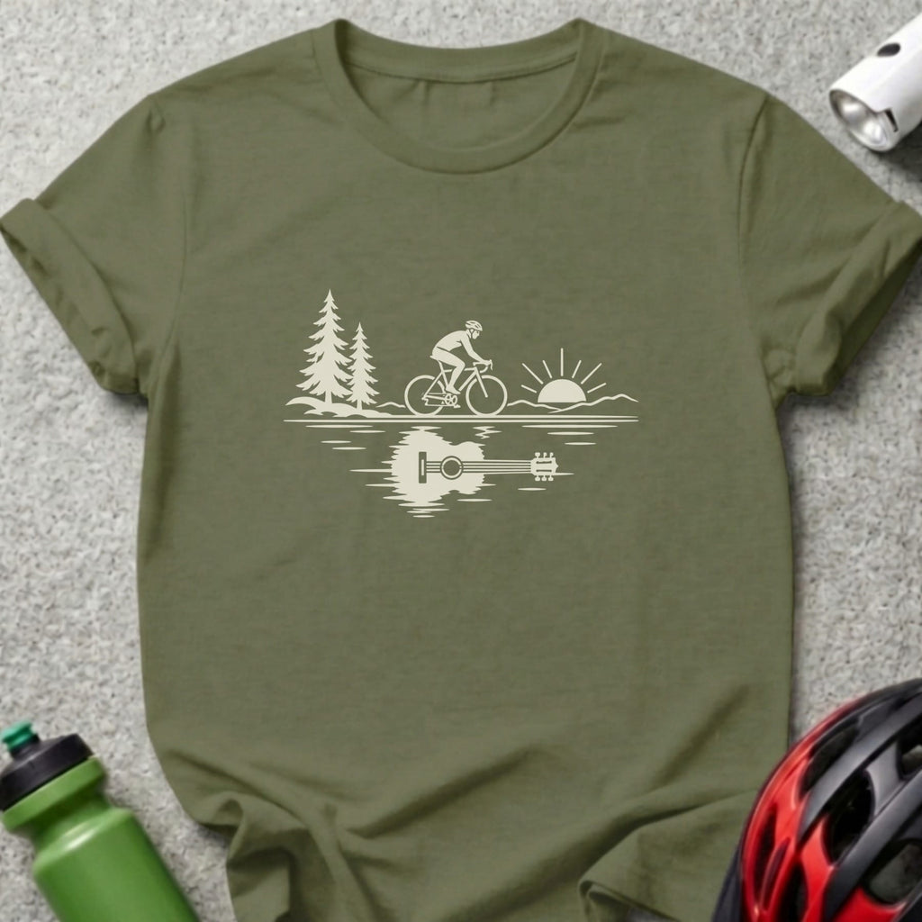 An olive green t-shirt with a white graphic of a cyclist, trees, and a guitar reflection.