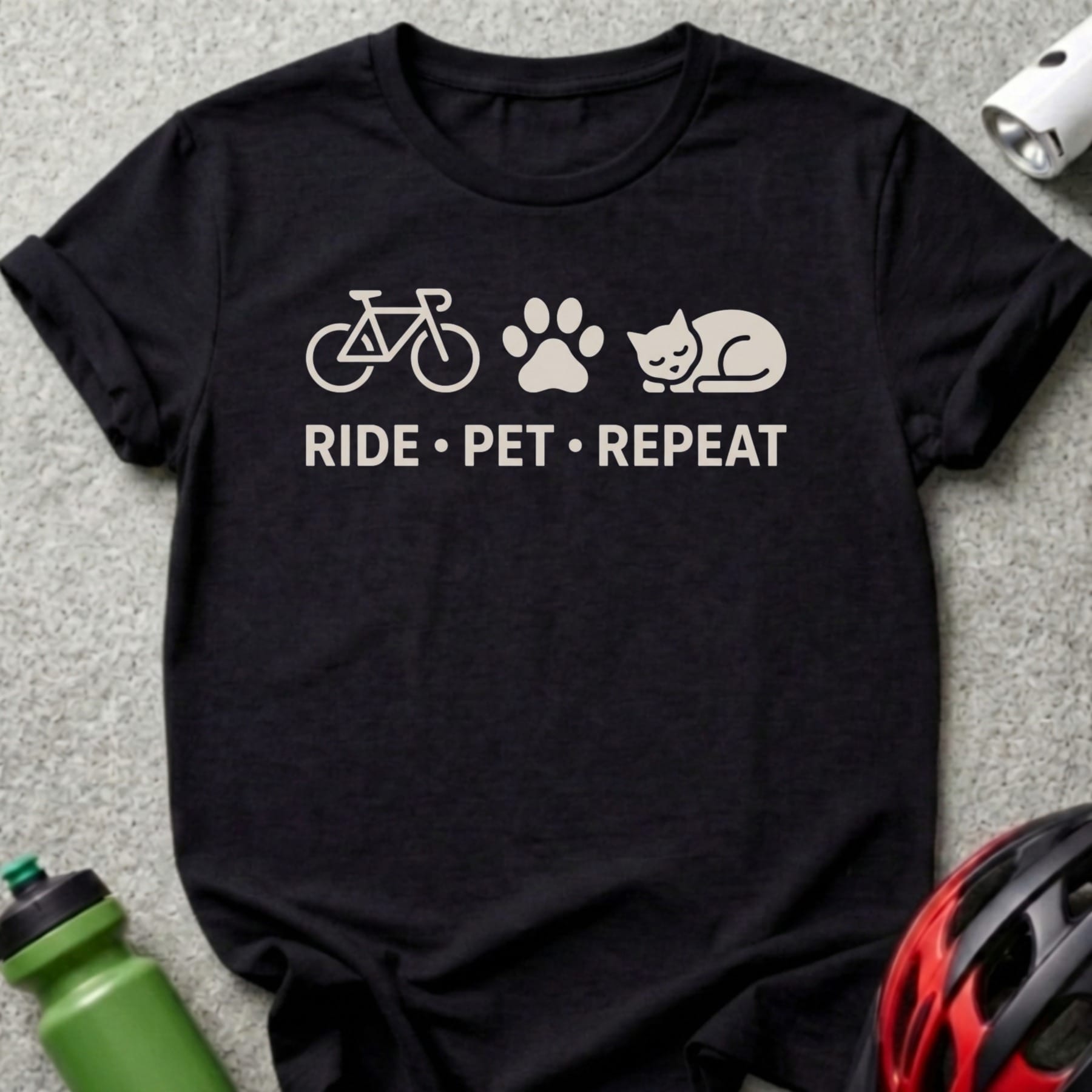 Black t-shirt with bicycle, paw print, and cat icons above "RIDE • PET • REPEAT" text.
