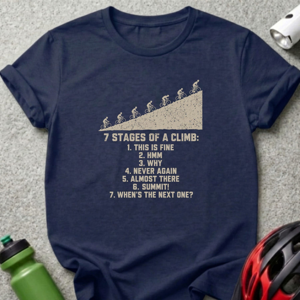 A dark blue t-shirt printed with bicycle graphics and the text 7 stages of a climb.