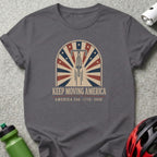 T-shirt with bicycle wheel design and text "KEEP MOVING AMERICA AMERICA 250 1776-2026".