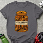 T-shirt with graphic of a pill bottle filled with bicycles and dogs.