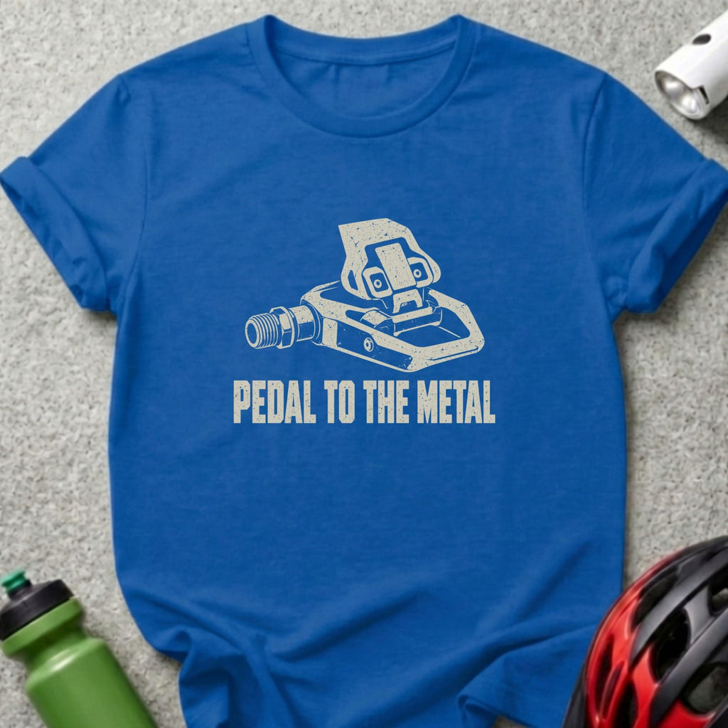 A royal blue crewneck t-shirt featuring a white bicycle pedal graphic and the text PEDAL TO THE METAL.