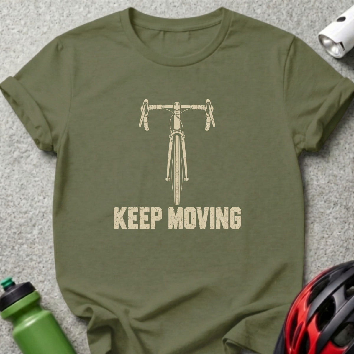An olive green t-shirt with a front graphic of a bicycle handlebars and the text "KEEP MOVING".
