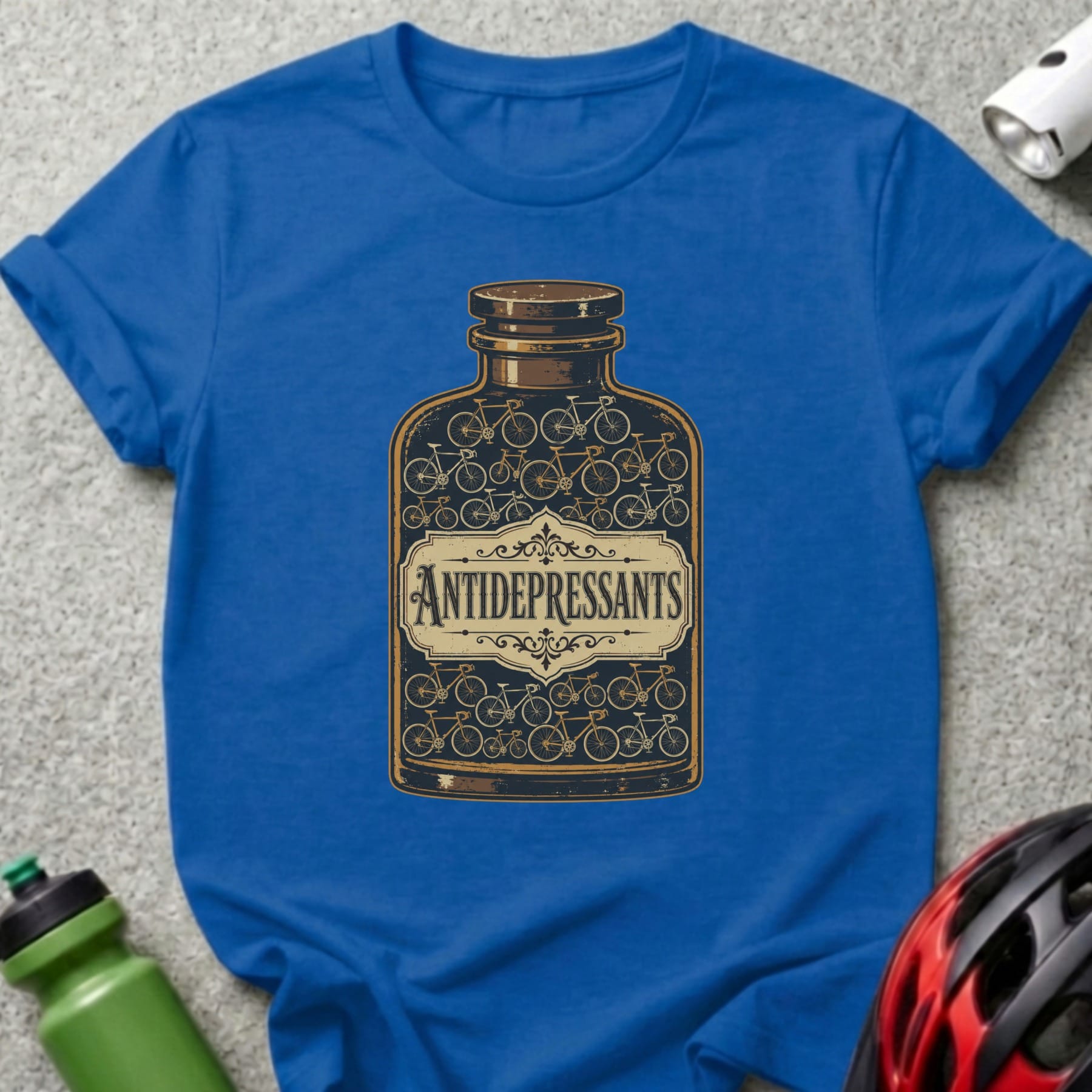 Blue t-shirt with bottle illustration labeled "ANTIDEPRESSANTS" filled with bicycles.