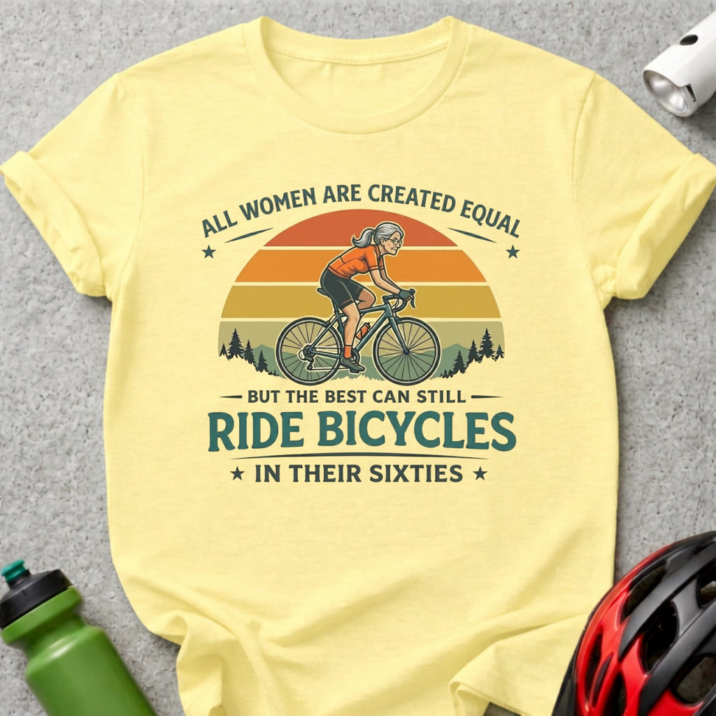 Yellow t-shirt with graphic featuring a woman cycling and the text "All women are created equal but the best can still ride bicycles in their sixties."