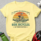 Yellow t-shirt with graphic featuring a woman cycling and the text "All women are created equal but the best can still ride bicycles in their sixties."