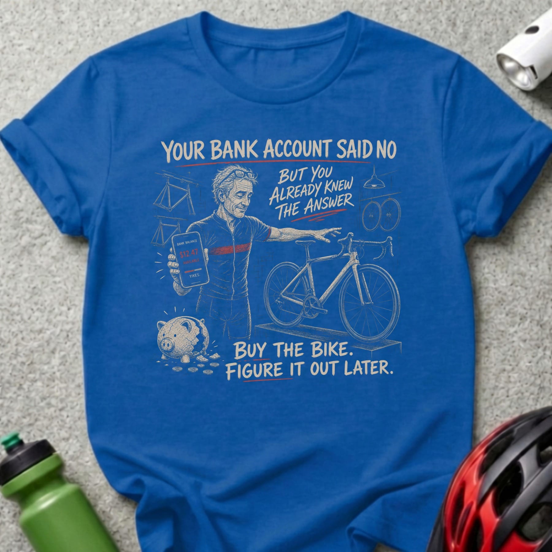 Blue t-shirt with cartoon man, piggy bank, and bicycle; text about buying a bike.