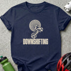 Navy blue t-shirt with a white graphic of bicycle gears and the text DOWNSHIFTING.