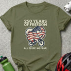 Green t-shirt with a patriotic dog riding a bike, text "250 Years of Freedom. All Fluff. No Fear."