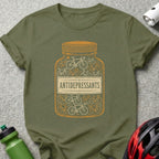 Olive green t-shirt with a graphic of a pill bottle filled with bicycles and the text "ANTIDEPRESSANTS".