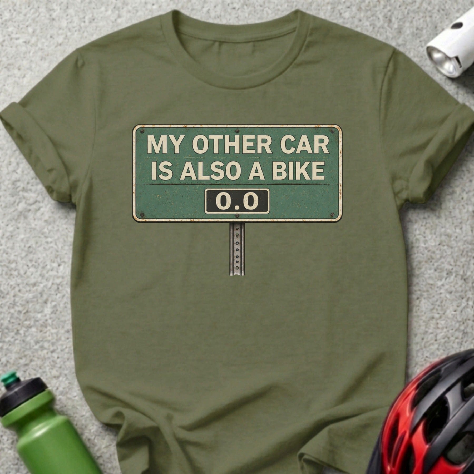 Olive green t-shirt with a sign that reads "MY OTHER CAR IS ALSO A BIKE 0.0".