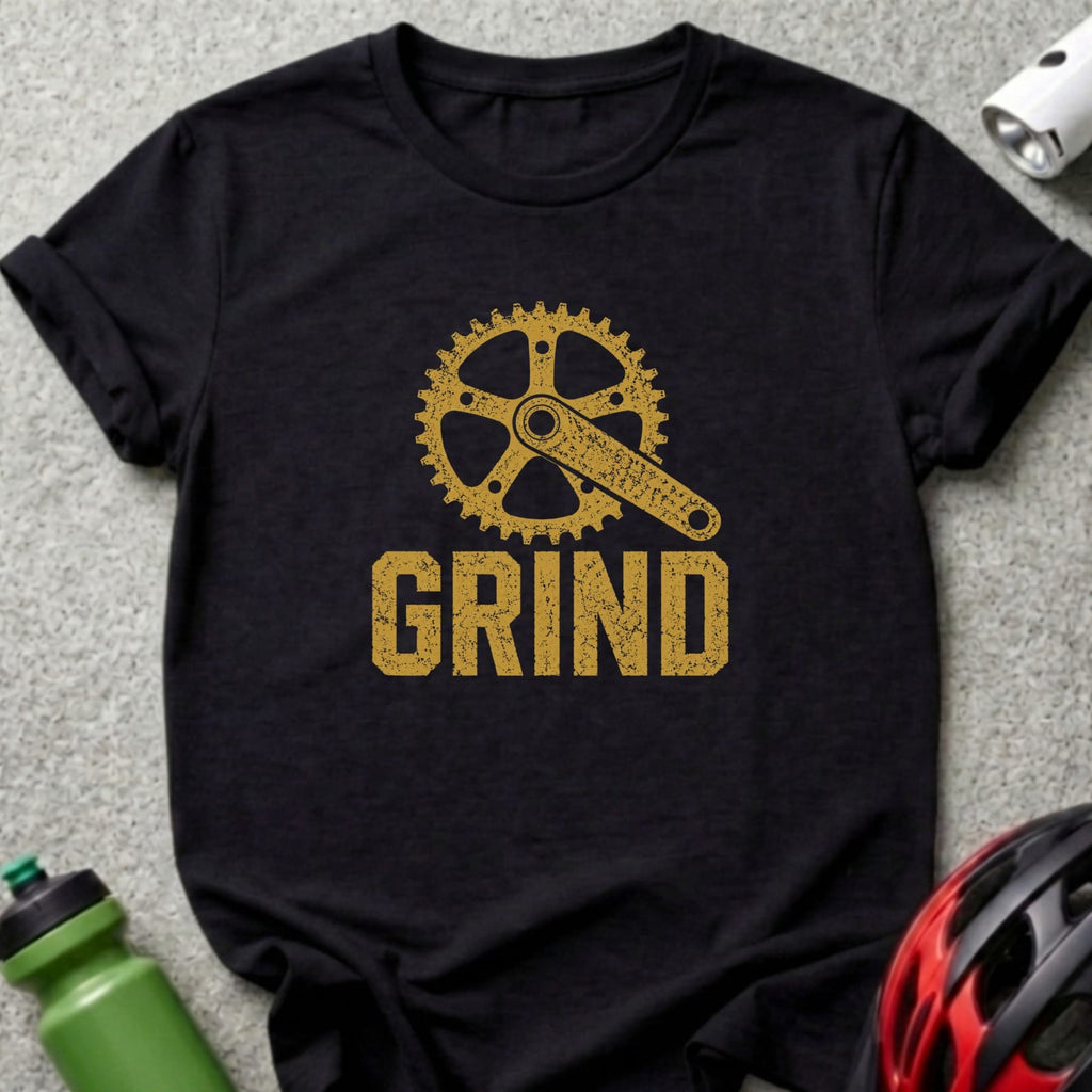 Black t-shirt with gold "GRIND" text and a bicycle crankset graphic.