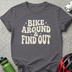 Dark grey t-shirt with "Bike Around & Find Out" text in cream lettering.
