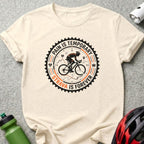 T-shirt with black and orange Strava logo featuring a cyclist and gear design.