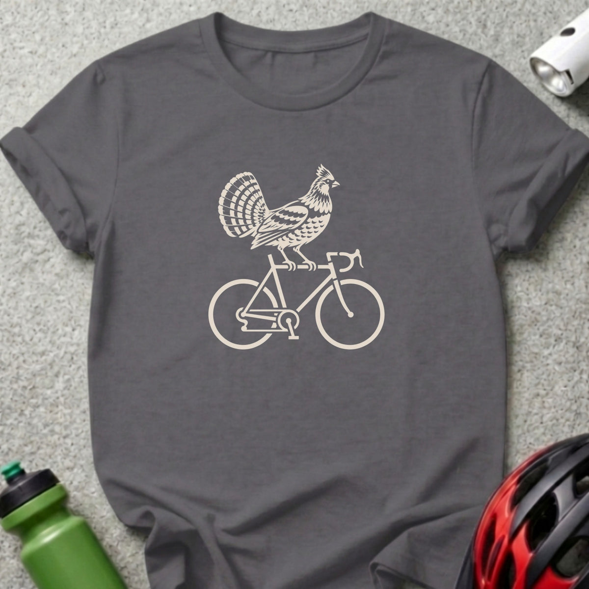 A dark gray t-shirt featuring a cream-colored graphic of a bird riding a bicycle.