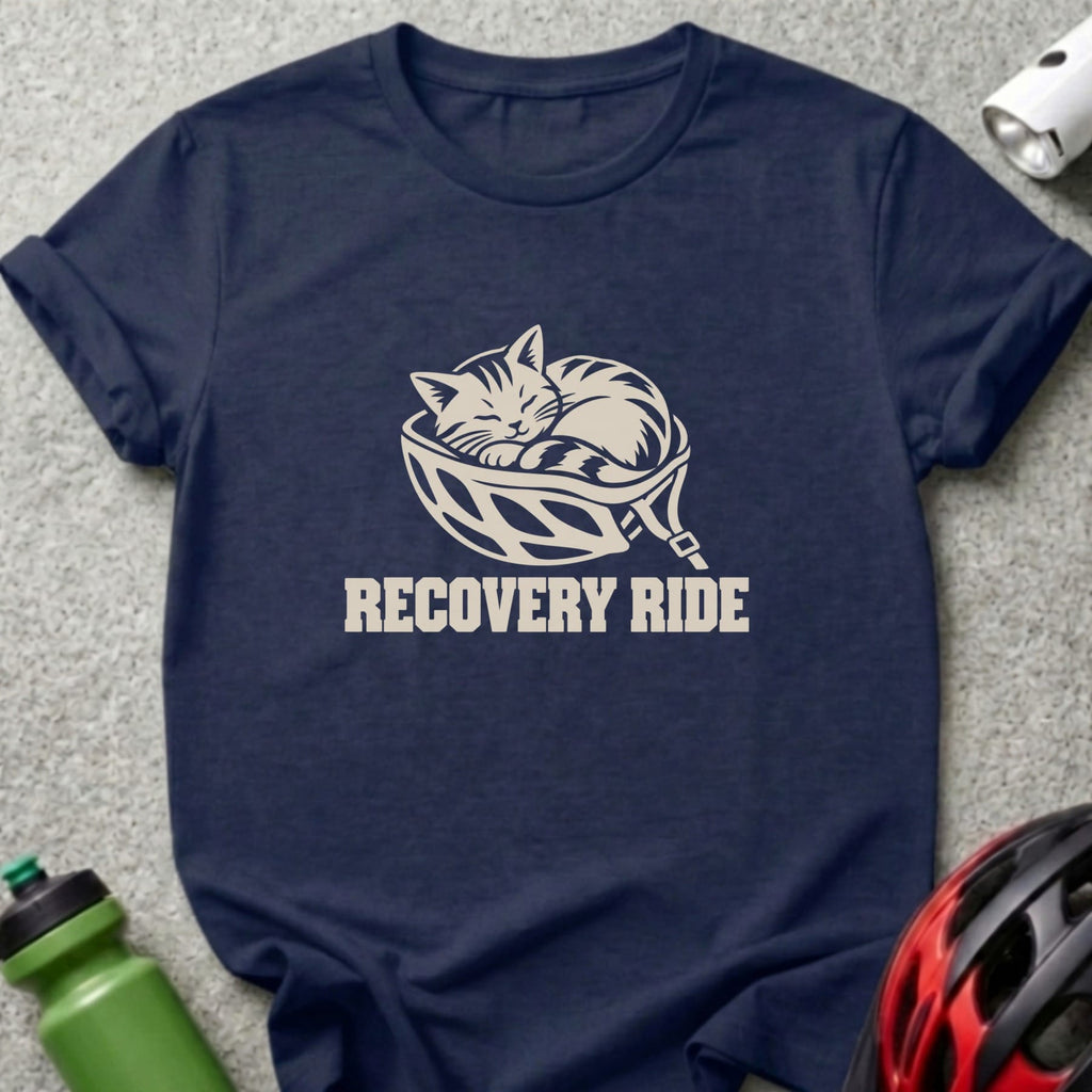Navy blue t-shirt featuring a cream graphic of a cat sleeping inside a bicycle helmet with the text RECOVERY RIDE.