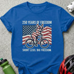 Blue t-shirt with French bulldog on bicycle, American flag, text "250 YEARS OF FREEDOM SHORT LEGS. BIG FREEDOM."