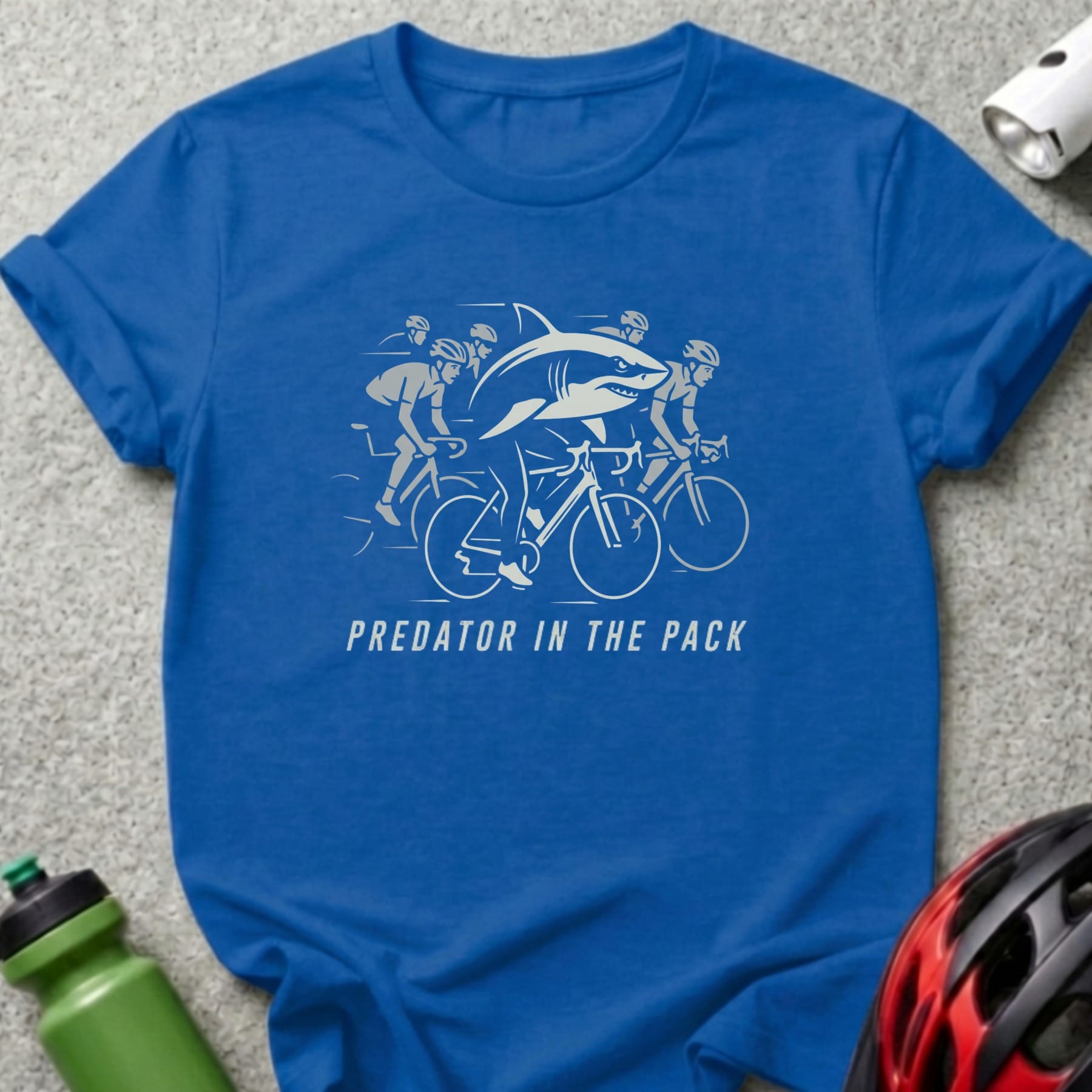 Blue t-shirt with "Predator in the Pack" text and a shark cycling with a group.