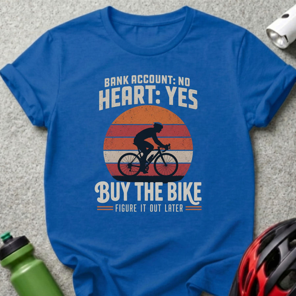 Blue t-shirt with cyclist graphic and text "BANK ACCOUNT: NO HEART: YES. BUY THE BIKE. FIGURE IT OUT LATER."