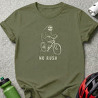 Olive green t-shirt with a sloth riding a bicycle and the text "NO RUSH".