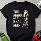 Black t-shirt with graphic: "The Mark of a Real Man" and a cleated football boot.